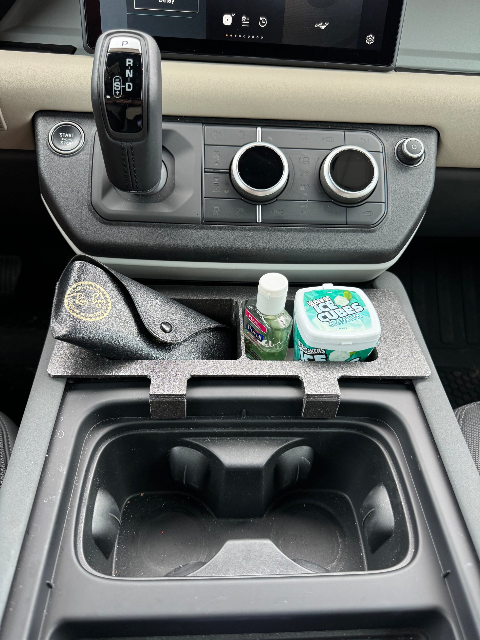 Land Rover Defender caddy for functional storage in center console.