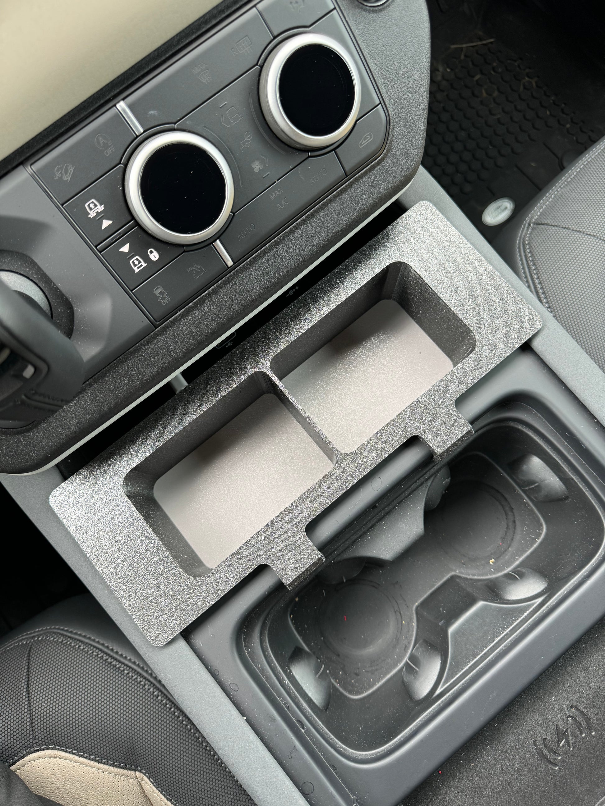 Land Rover Defender caddy for functional storage in center console.