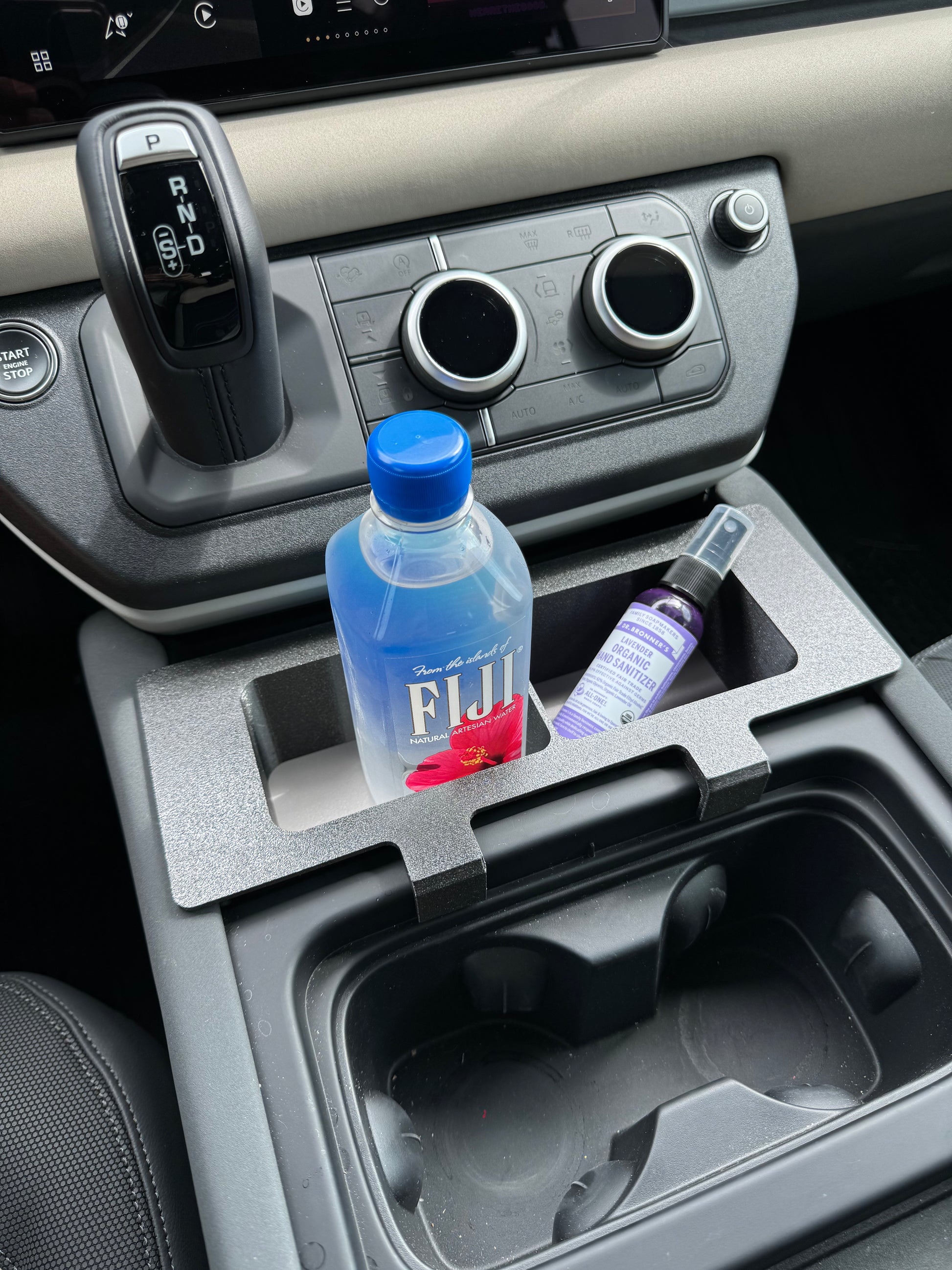 Land Rover Defender caddy for extra storage in center console.