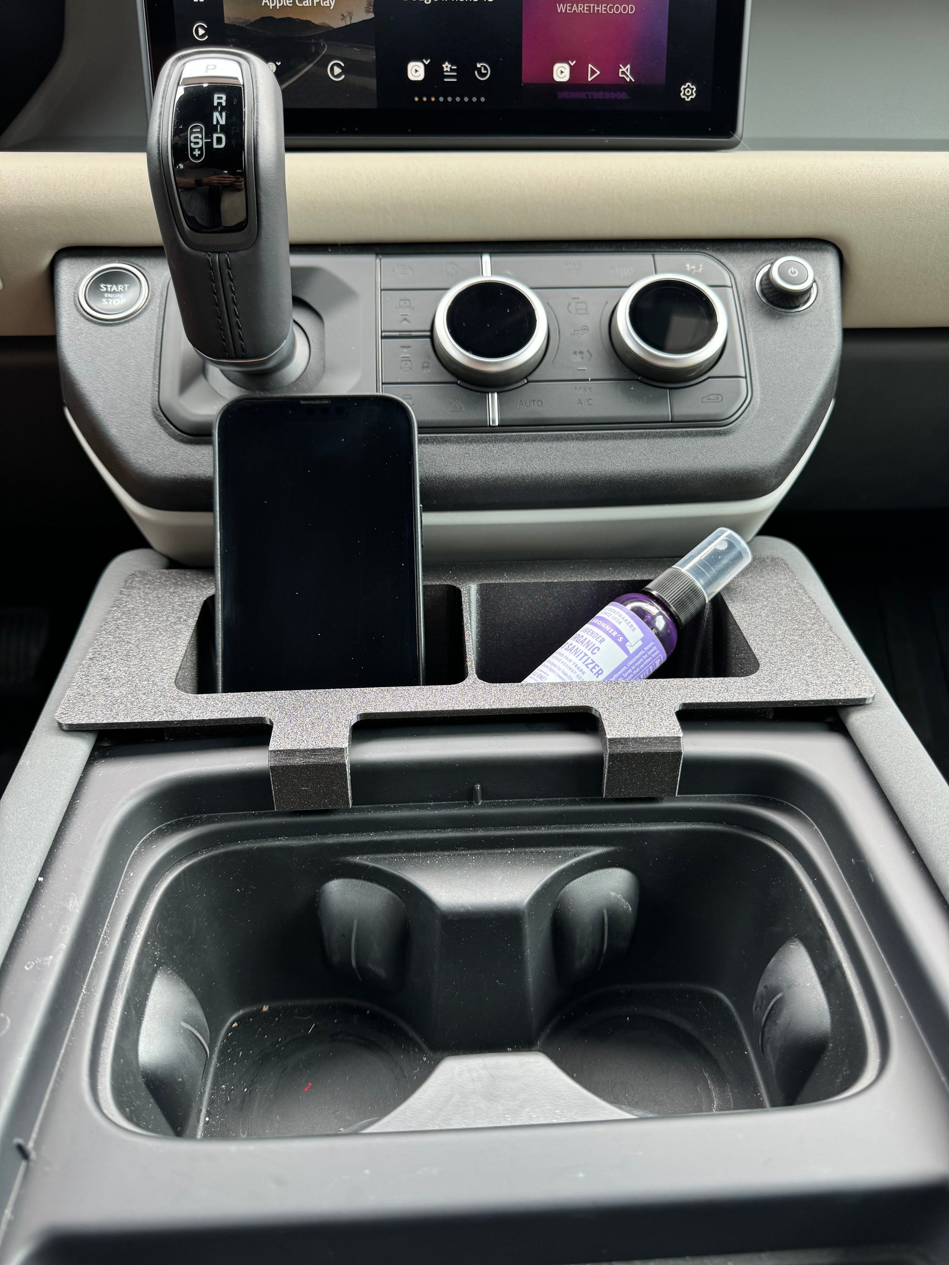 Land Rover Defender caddy for phone/iPhone storage in center console.