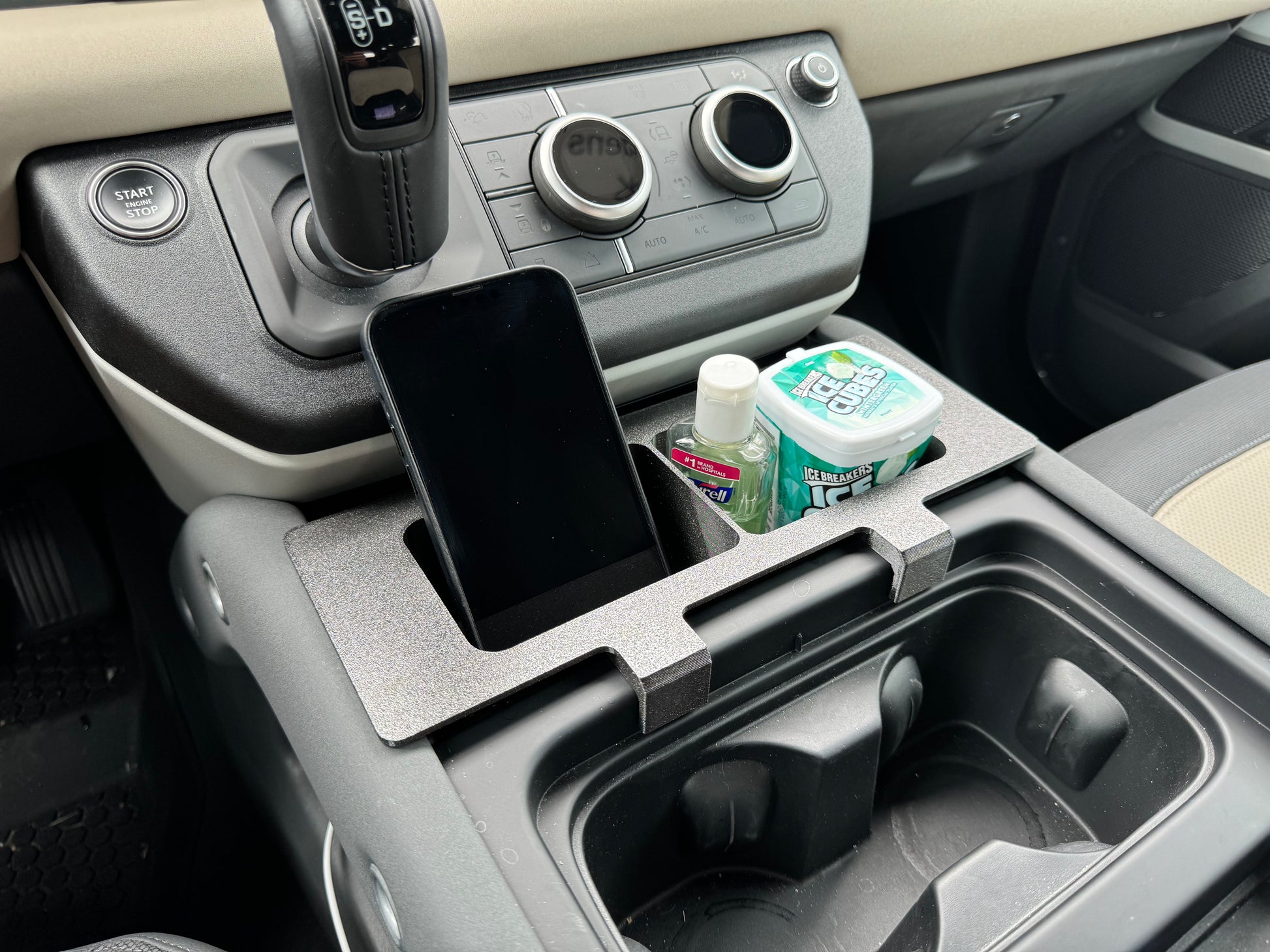 Land Rover Defender caddy for additional storage in center console.