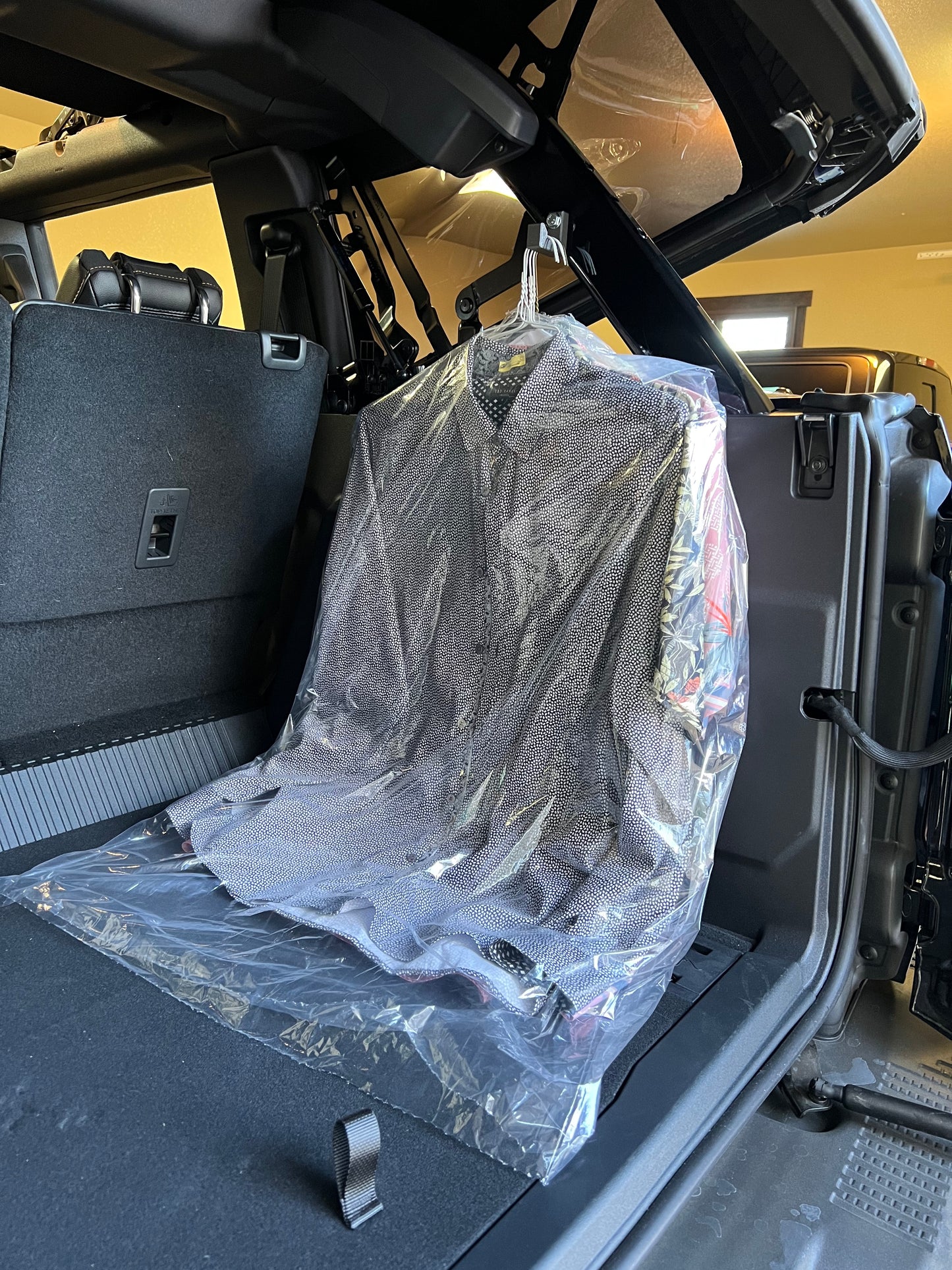 Dry cleaning hanging from Ford Bronco gear hooks