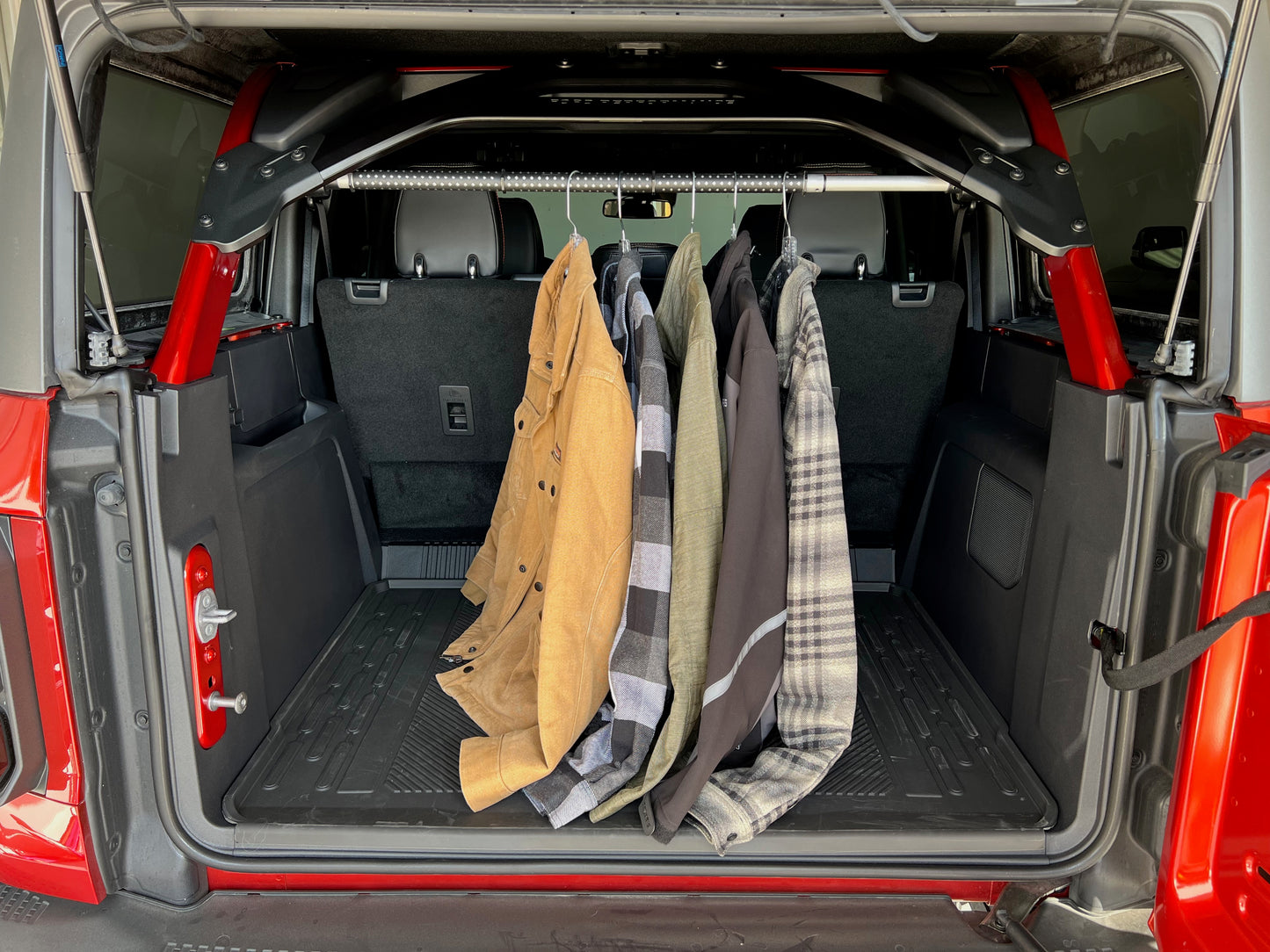 Clothes hanging from garment rod of Ford Bronco