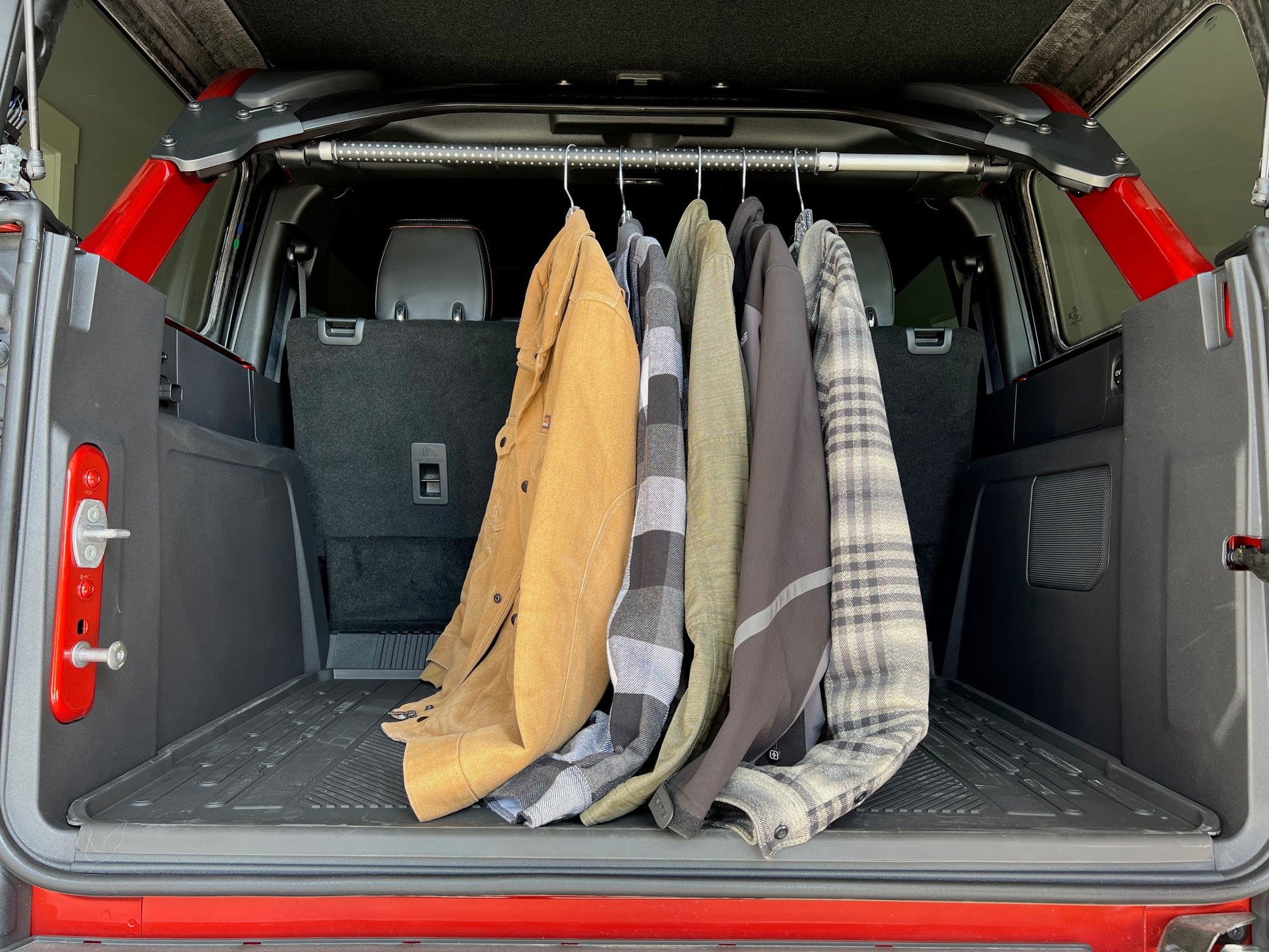Garment rod hanging in back of Ford Bronco